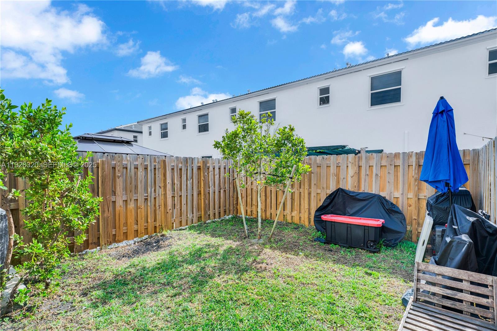 16266 Southwest 291st Street Homestead, FL 33033 - Photo 31 of 34 a view of a backyard with furniture and a garage