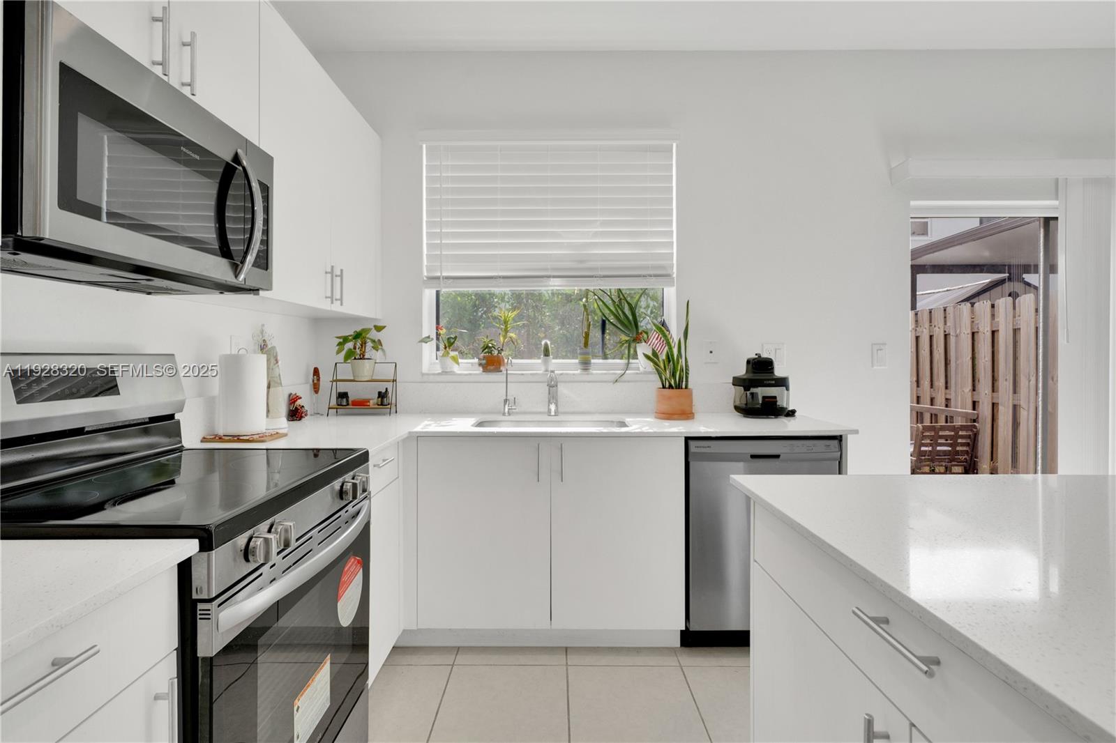 16266 Southwest 291st Street Homestead, FL 33033 - Photo 4 of 34 a kitchen with a sink stove and microwave