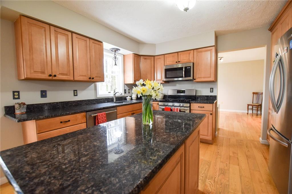 542 Fisher Road Cabot, PA 16023 - Photo 4 of 23 a kitchen with stainless steel appliances granite countertop a sink stove and refrigerator