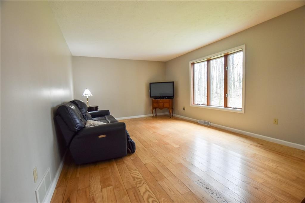 542 Fisher Road Cabot, PA 16023 - Photo 7 of 23 a living room with furniture and a flat screen tv