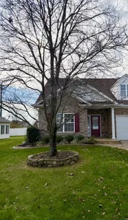 a front view of house with yard and green space