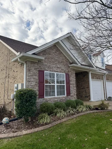 a front view of a house with a garden