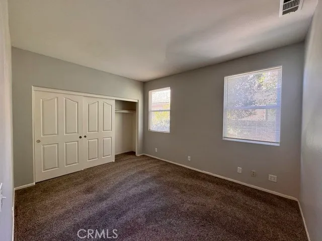 a kitchen with kitchen island granite countertop a sink cabinets and wooden floor