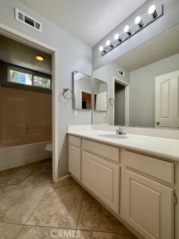 a kitchen with counter top space and living room