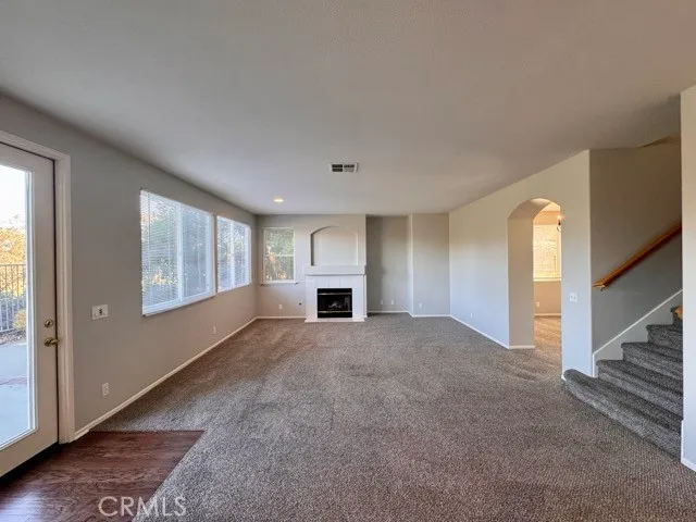 a view of hallway with stairs and wooden floor