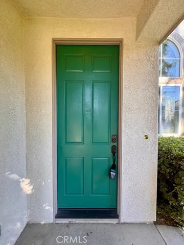 a view of a big room with windows and chandelier