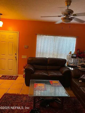 a living room with furniture and a rug