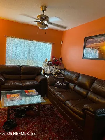 a living room with furniture and a rug