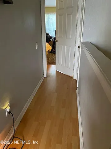 a bedroom with a bed and a wall painting