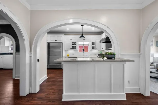 a kitchen with stainless steel appliances a refrigerator sink and cabinets
