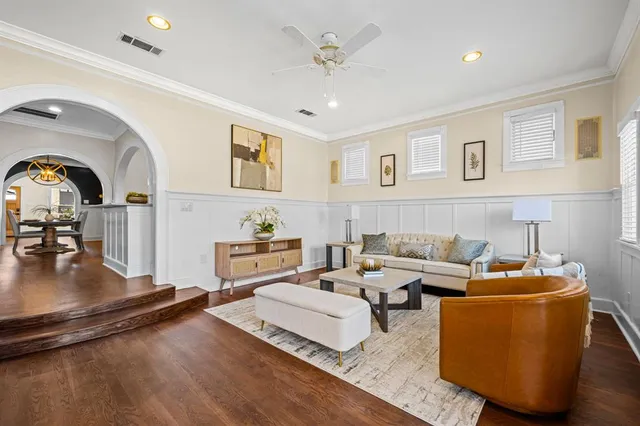 a living room with furniture and a wooden floor