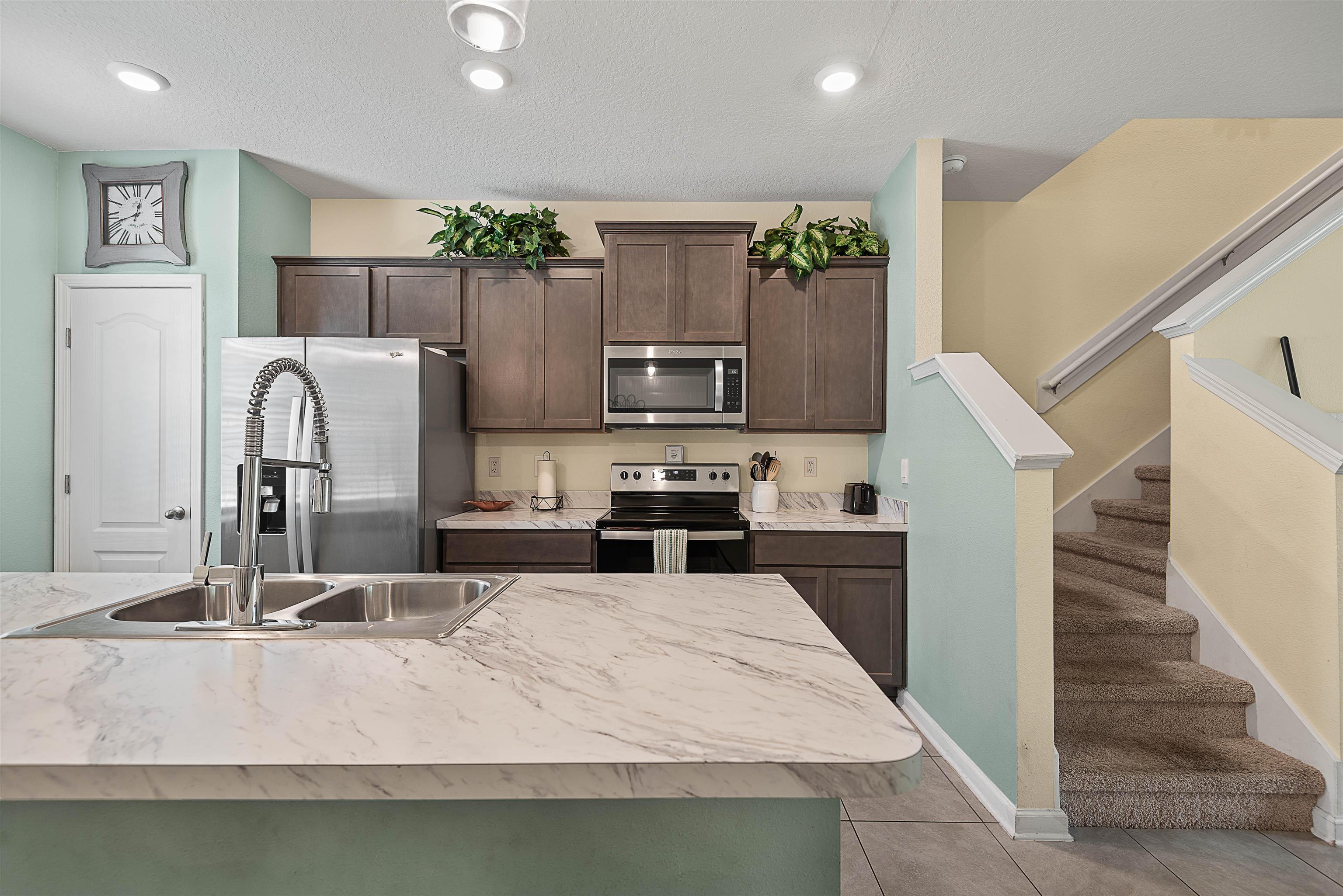877 Rotary Road Jacksonville, FL 32211 - Photo 18 of 36 a kitchen with stainless steel appliances granite countertop a sink refrigerator and microwave