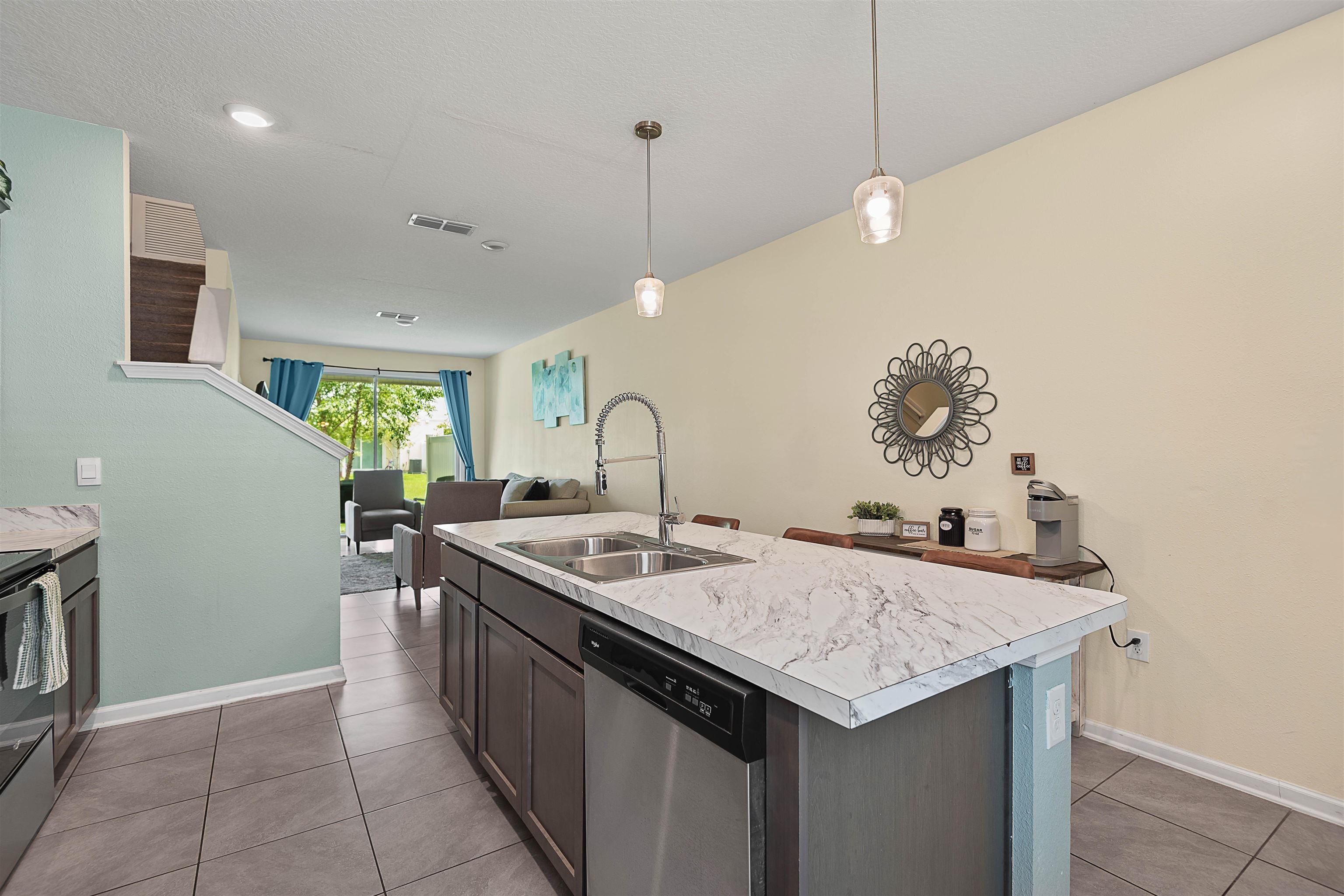 877 Rotary Road Jacksonville, FL 32211 - Photo 24 of 36 a kitchen that has a sink a stove and a table with chairs