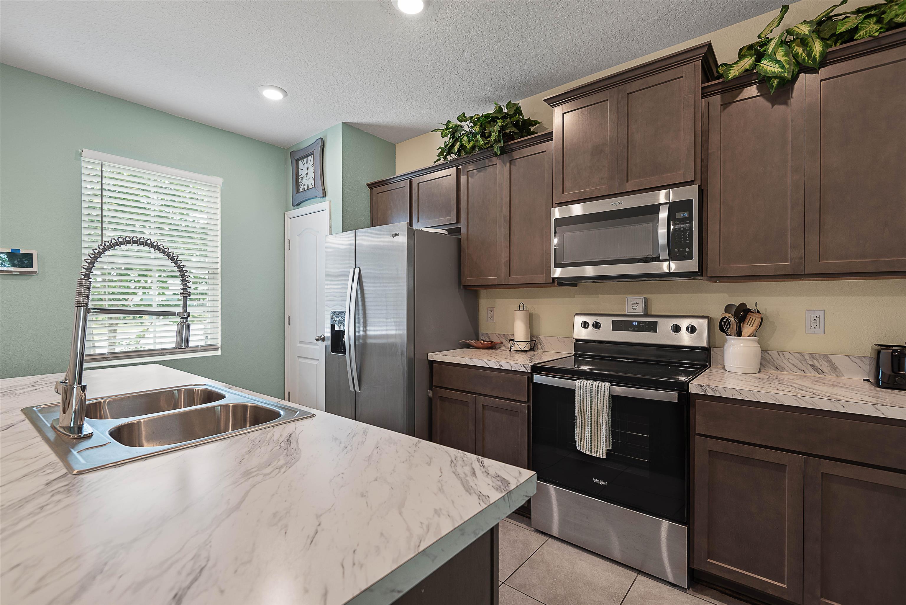 877 Rotary Road Jacksonville, FL 32211 - Photo 25 of 36 a kitchen with granite countertop a sink stainless steel appliances and cabinets