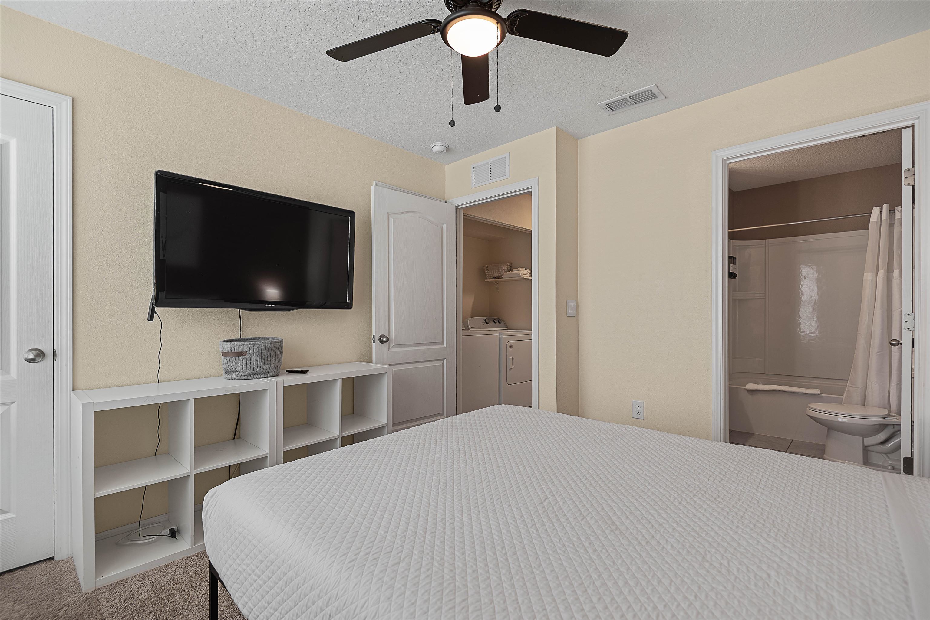877 Rotary Road Jacksonville, FL 32211 - Photo 29 of 36 a bedroom with a bed and a flat screen tv