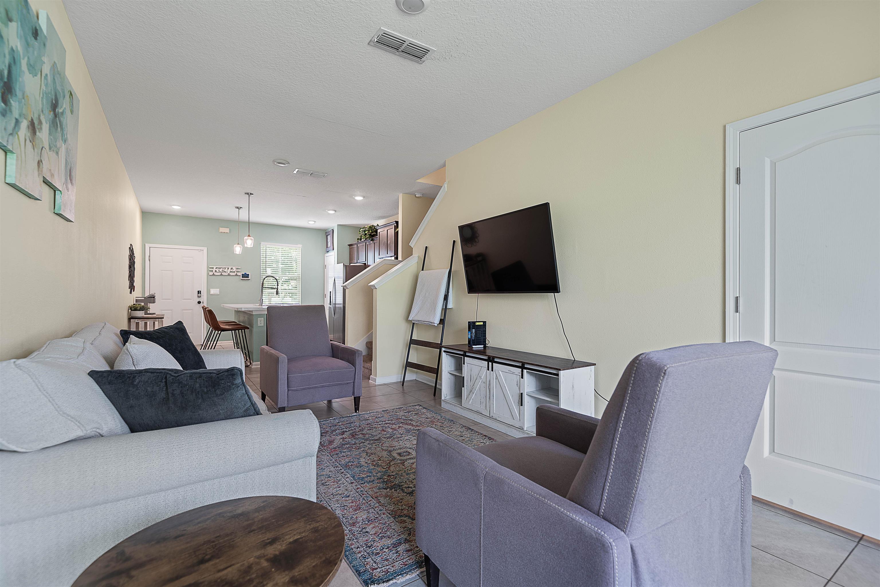 877 Rotary Road Jacksonville, FL 32211 - Photo 4 of 36 a living room with furniture and a flat screen tv