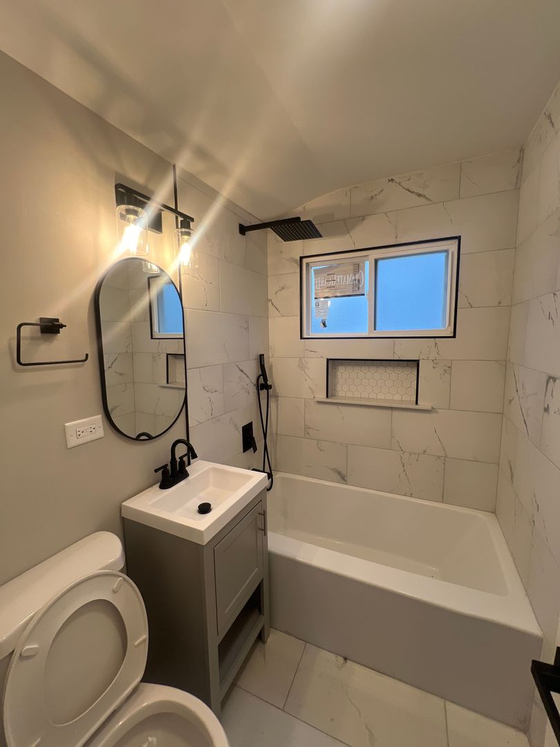 Undisclosed Address Markham, IL 60428 - Photo 11 of 22 a bathroom with a sink a toilet and a bathtub