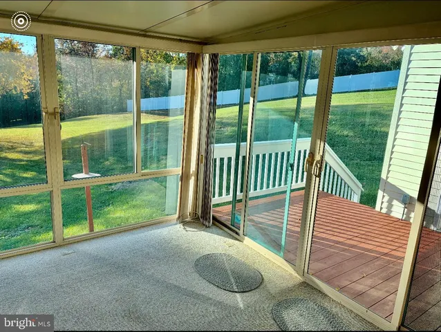 a view of a deck with a floor to ceiling window
