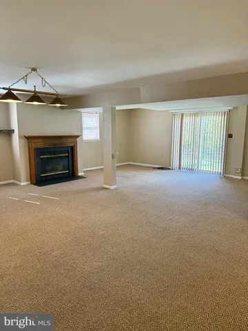 a view of empty room with a fireplace