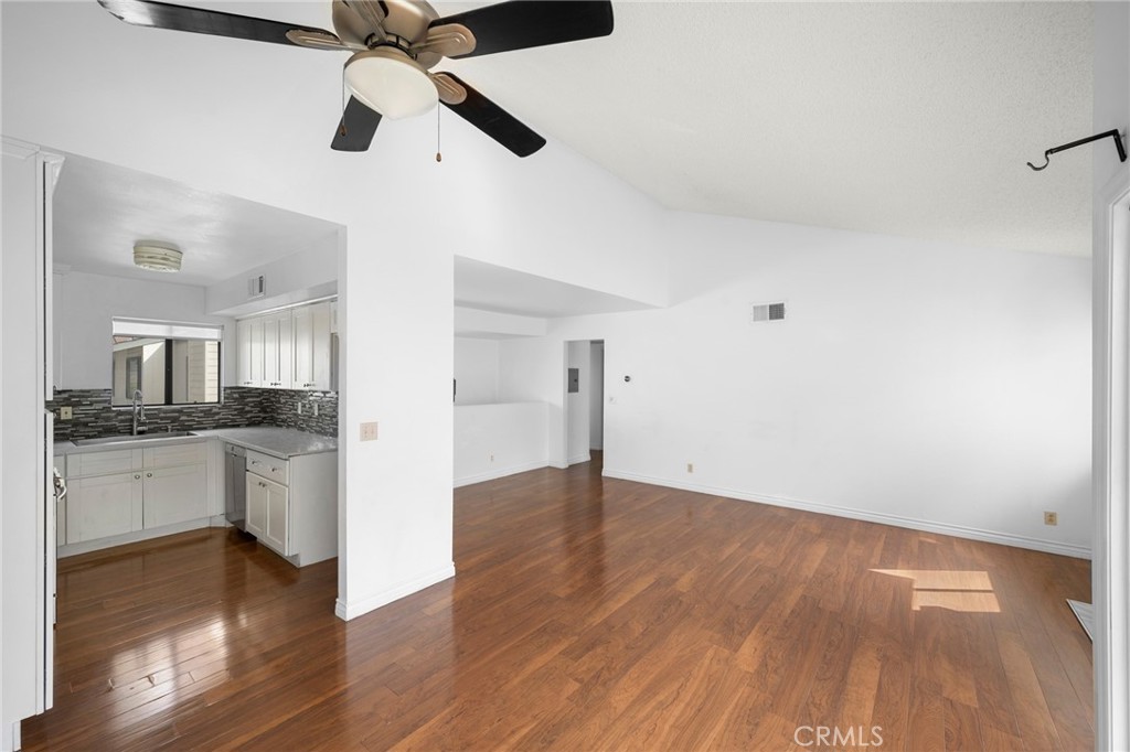 10475 Newhome Avenue, Unit 6 Sunland, CA 91040 - Photo 15 of 28 a view of an empty room and kitchen with wooden floor