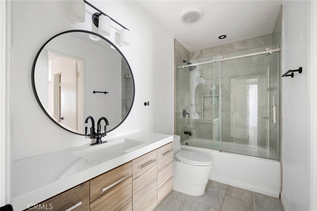 10475 Newhome Avenue, Unit 6 Sunland, CA 91040 - Photo 22 of 28 a bathroom with a toilet a sink and a mirror
