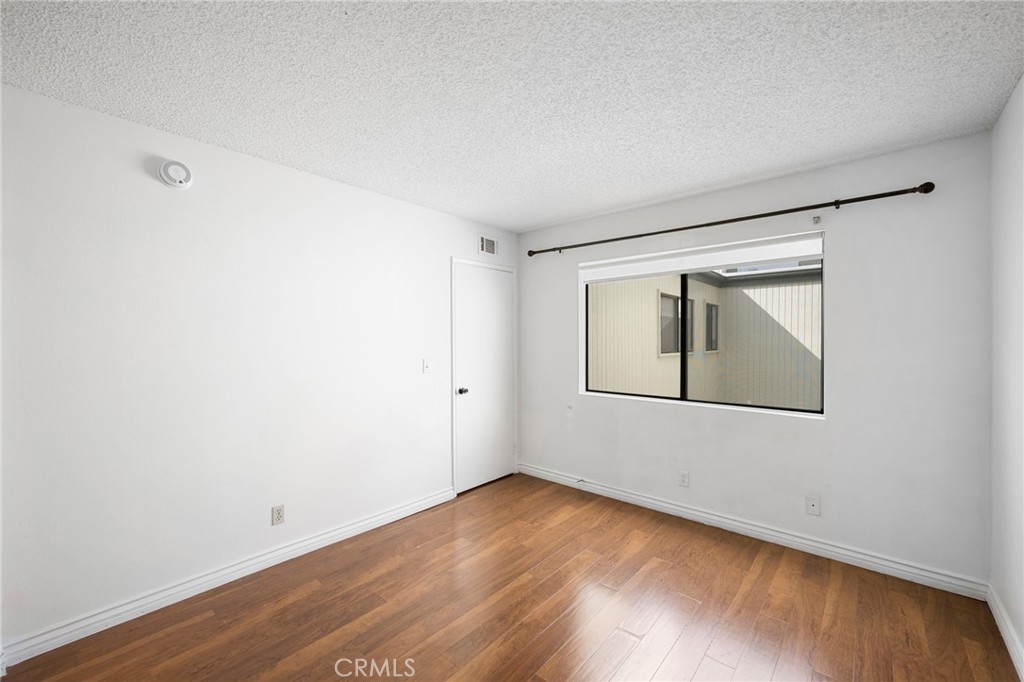 10475 Newhome Avenue, Unit 6 Sunland, CA 91040 - Photo 24 of 28 a view of an empty room with wooden floor and closet