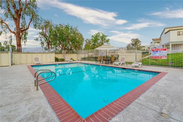 swimming pool view with a garden space