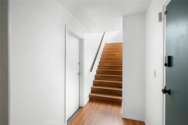 a view of a hallway with wooden floor and entryway