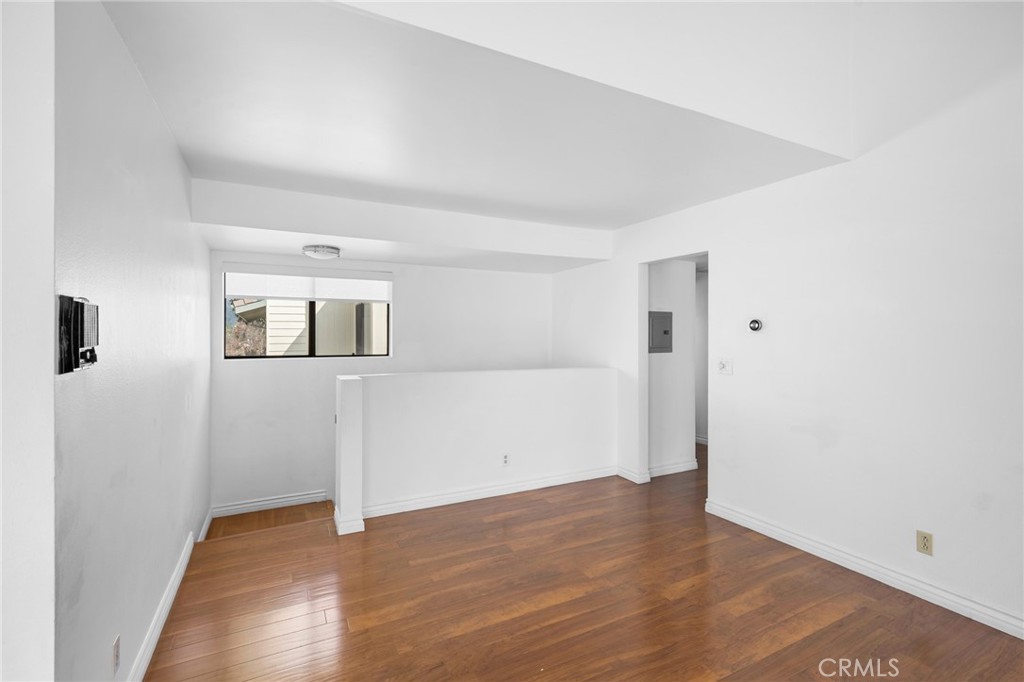 10475 Newhome Avenue, Unit 6 Sunland, CA 91040 - Photo 4 of 28 an empty room with wooden floor and windows