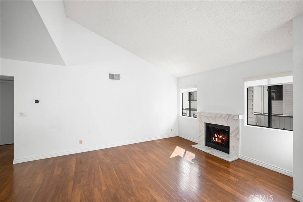 10475 Newhome Avenue, Unit 6 Sunland, CA 91040 - Photo 7 of 28 a view of empty room with wooden floor and fireplace