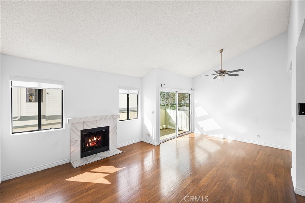 10475 Newhome Avenue, Unit 6 Sunland, CA 91040 - Photo 8 of 28 an empty room with windows fireplace and wooden floor