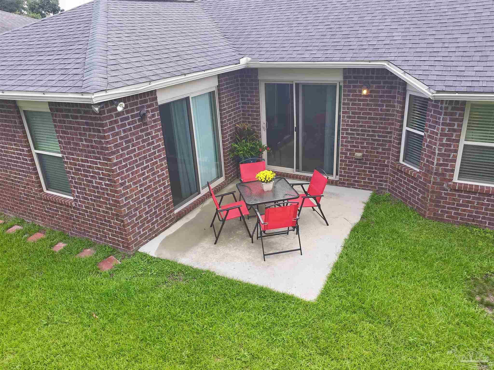 5709 Mill Stream Way Pace, FL 32571 - Photo 11 of 48 a bench is sitting in front of a house