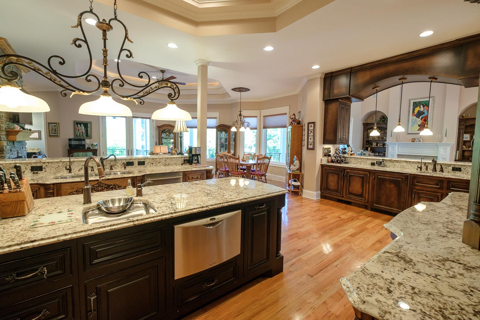247 Canoe Branch Road Lebanon, TN 37087 - Photo 12 of 30 a kitchen with stainless steel appliances granite countertop a sink a stove and a wooden floors