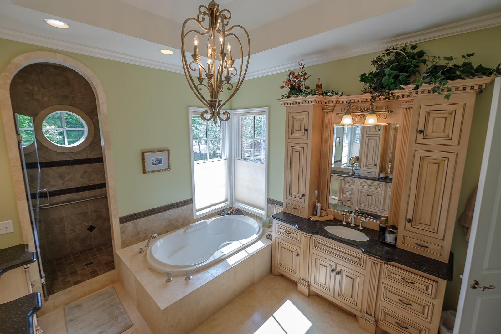 247 Canoe Branch Road Lebanon, TN 37087 - Photo 5 of 30 a spacious bathroom with a granite countertop sink a large mirror and a bathtub