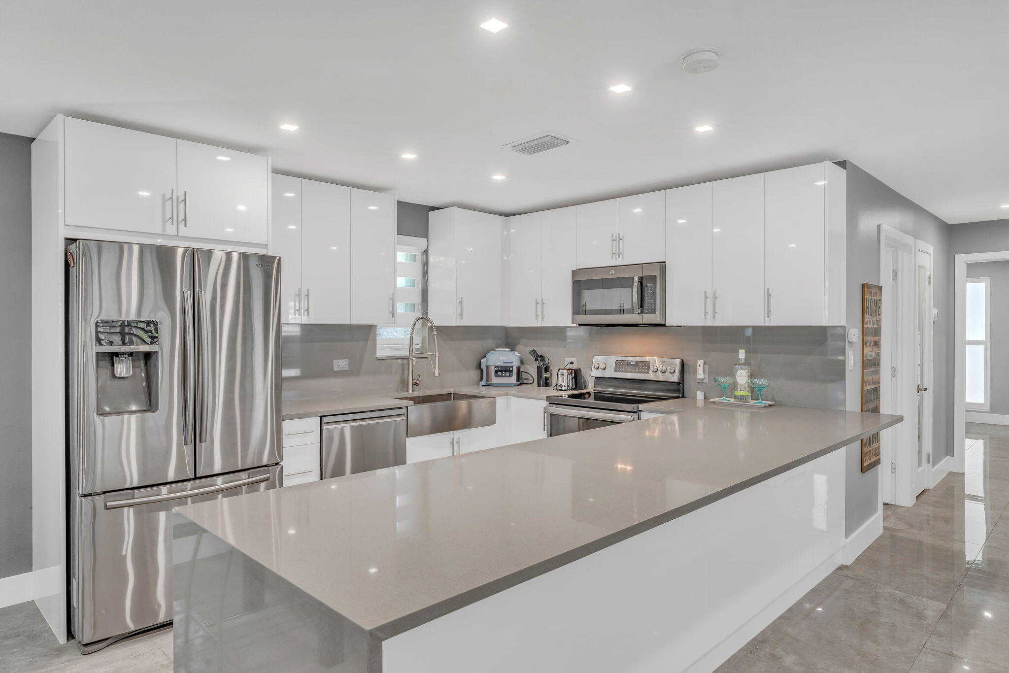 222 2nd Road Key Largo, FL 33037 - Photo 11 of 43 a kitchen with stainless steel appliances granite countertop a refrigerator a stove a sink a microwave and cabinets