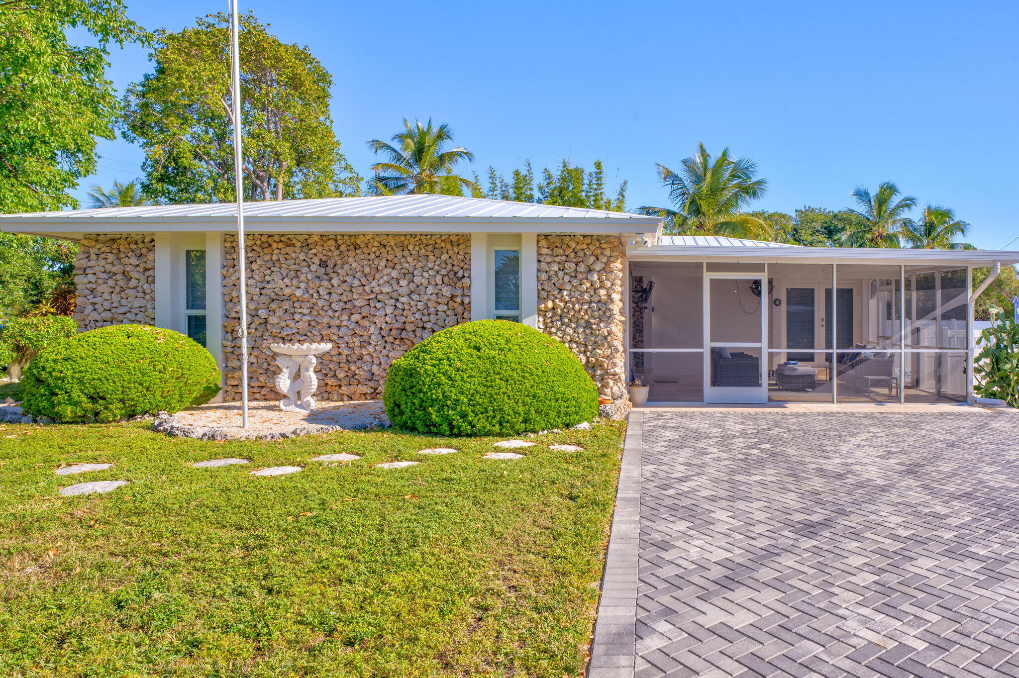 222 2nd Road Key Largo, FL 33037 - Photo 2 of 43 a view of a house with a yard and potted plants