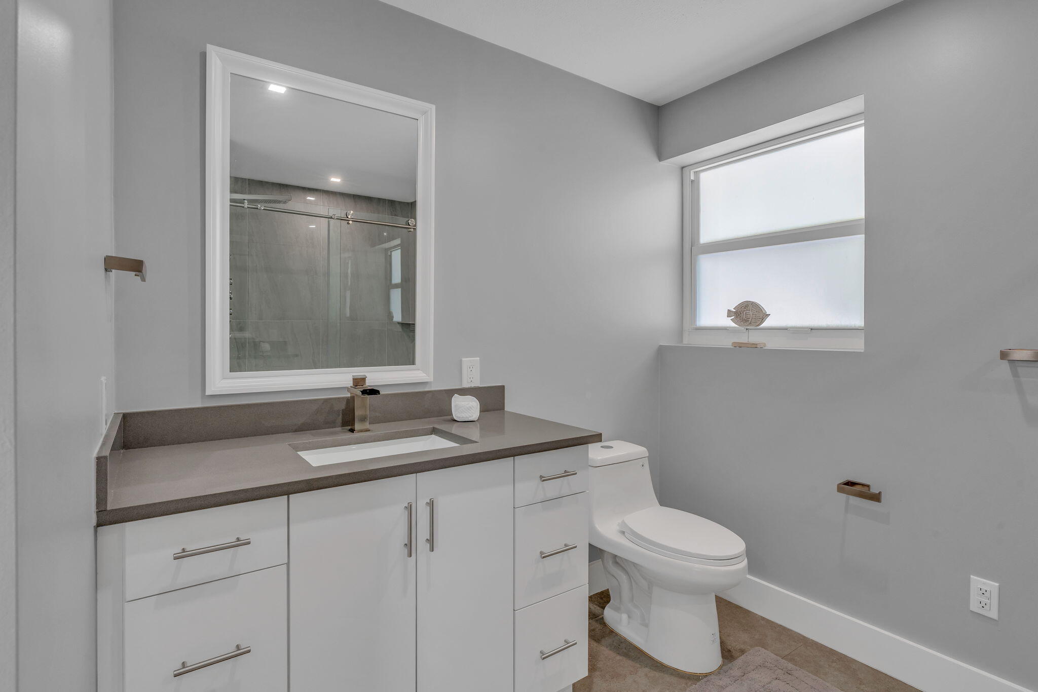 222 2nd Road Key Largo, FL 33037 - Photo 23 of 43 a bathroom with a granite countertop sink toilet a large mirror and a window