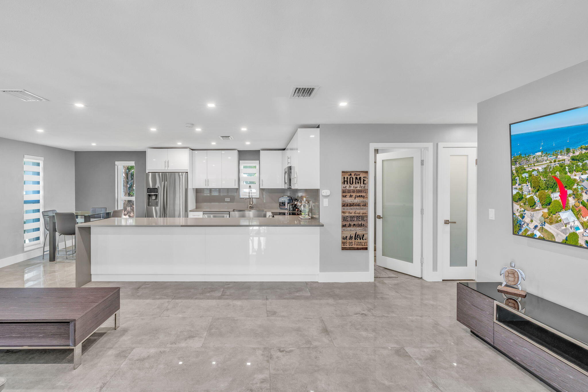 222 2nd Road Key Largo, FL 33037 - Photo 3 of 43 a view of kitchen with kitchen island white cabinets and refrigerator