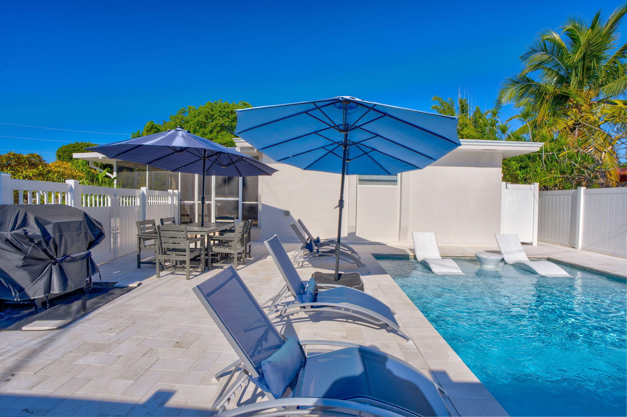 222 2nd Road Key Largo, FL 33037 - Photo 33 of 43 a view of a patio with chairs under an umbrella