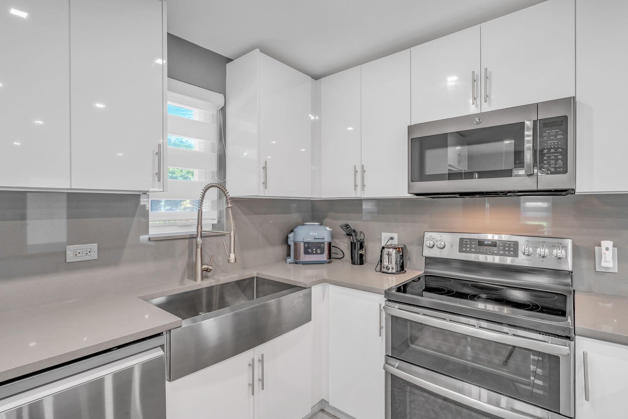 222 2nd Road Key Largo, FL 33037 - Photo 8 of 43 a kitchen with sink a microwave and cabinets