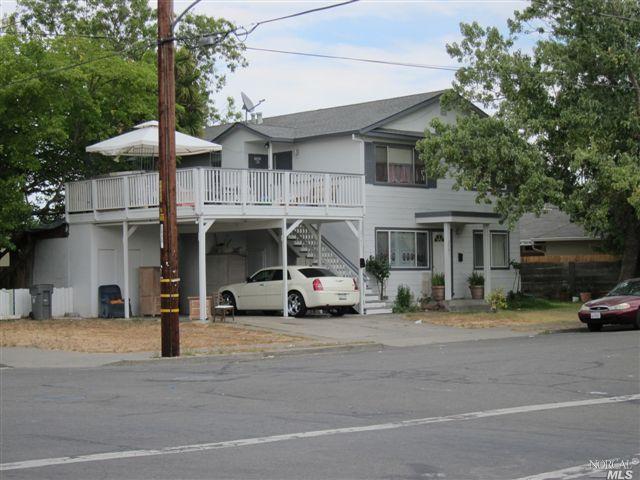 a view of a cars park in front of a building