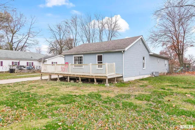 a view of a house with pool and a yard