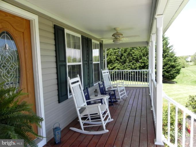 123 Quail Run Road Summit Point, WV 25446 - Photo 22 of 25 a view of balcony with furniture and wooden deck