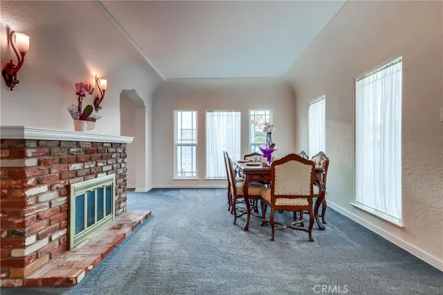 a kitchen with stainless steel appliances kitchen island granite countertop a stove and a refrigerator