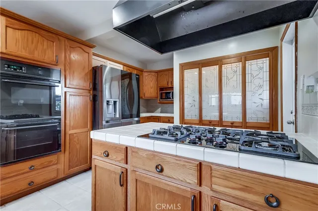a view of a house with a yard and potted plants