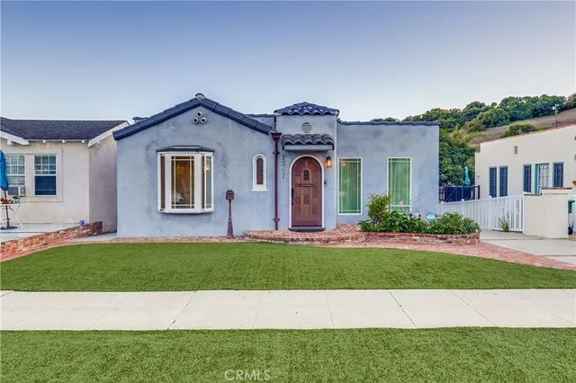 a front view of house with yard and green space