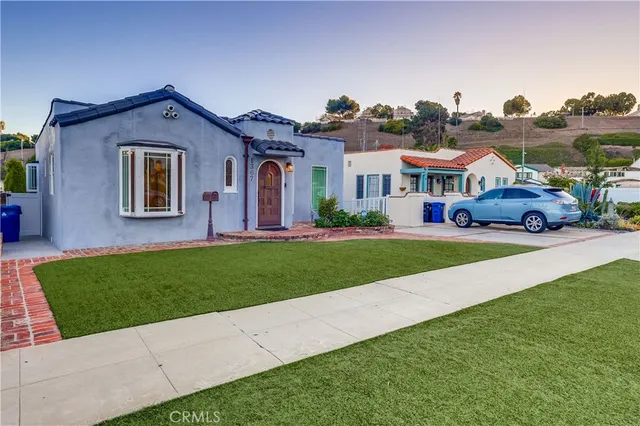 a bedroom with a bed and a potted plant