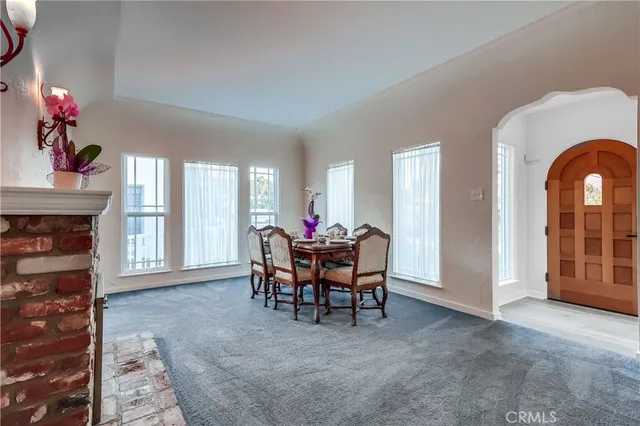 a dining room with furniture and a potted plant