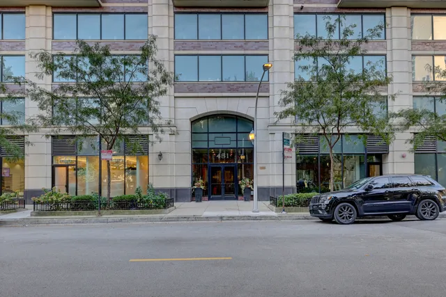 a couple of cars parked in front of a building