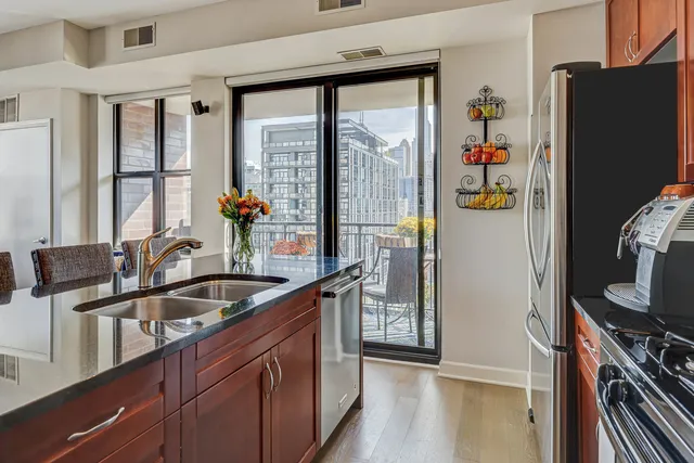 a kitchen with refrigerator a stove and a sink
